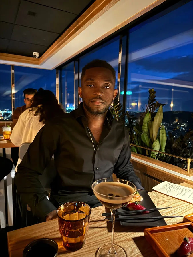 Dinner beside a window overlooking the city at dusk.