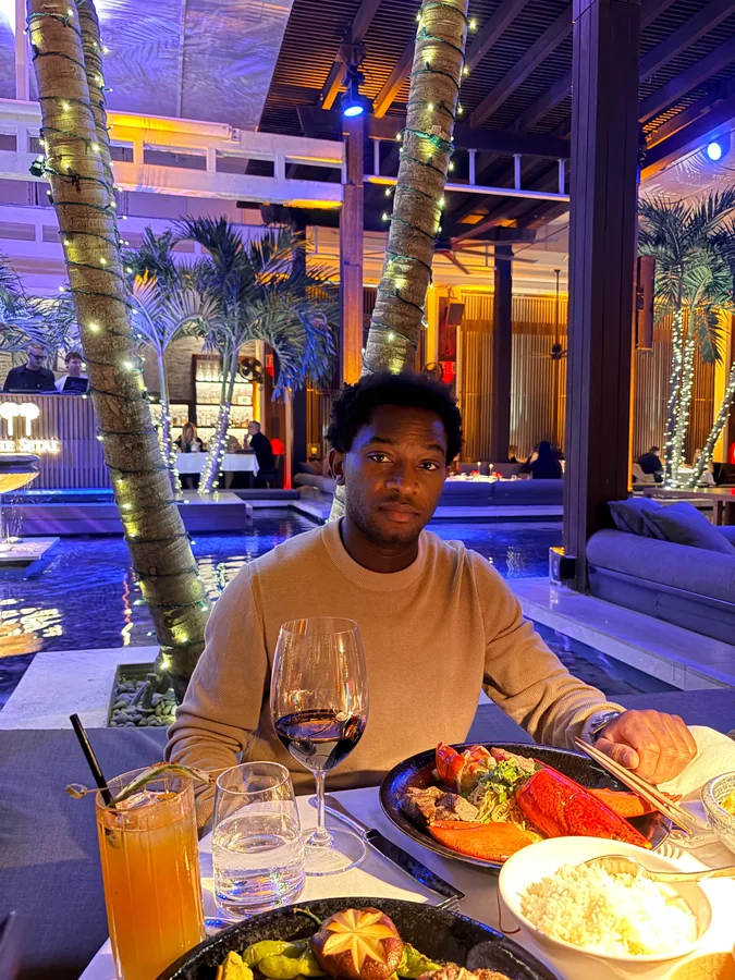 Dinner at Sekai in Miami, under colorful lights and palm trees.