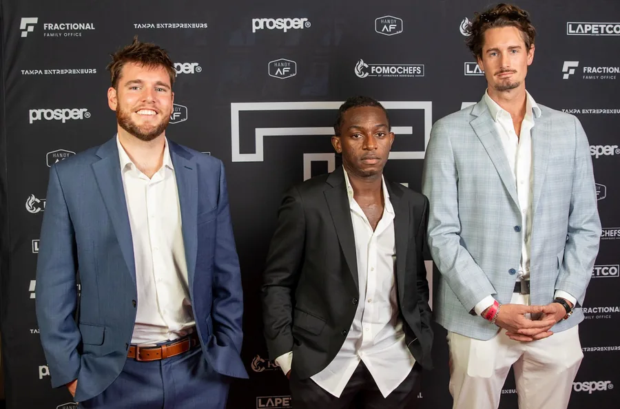 Three guests dressed in suits at an event in Tampa.