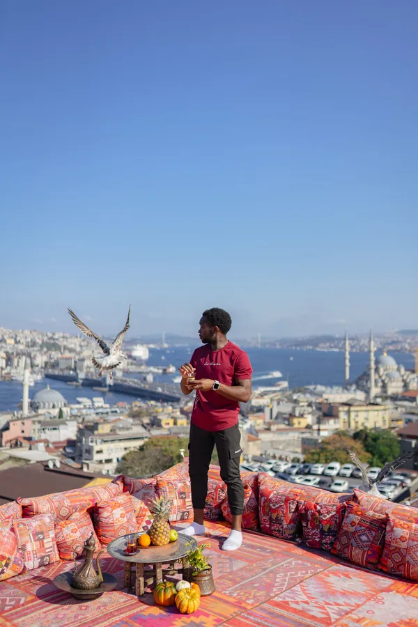 A traveler on a rooftop overlooking Istanbul.